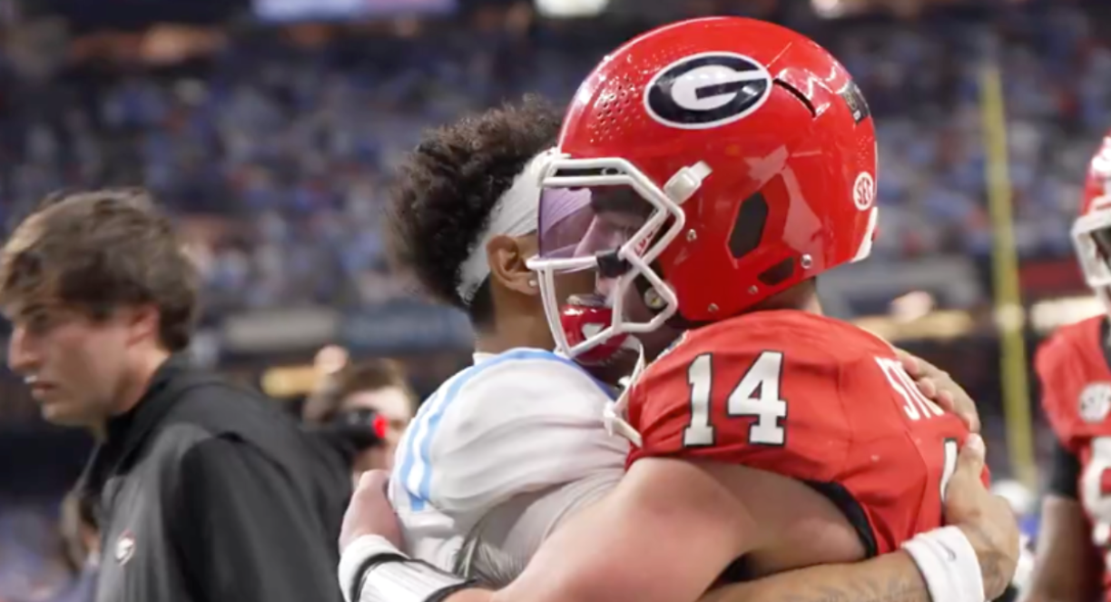 Ole Miss QB Trinidad Chambliss hugs Georgia's Gunner Stockton.